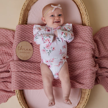 Baby wearing Camille Long Sleeve Organic Bodysuit with Frill | Snuggle Hunny