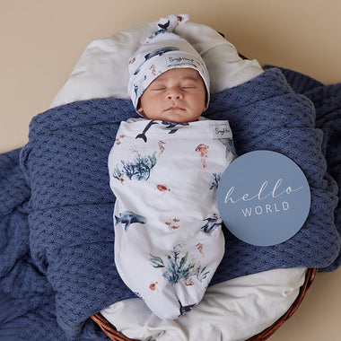 Baby wrapped in Ocean Organic Snuggle Swaddle & Beanie Set | Snuggle Hunny